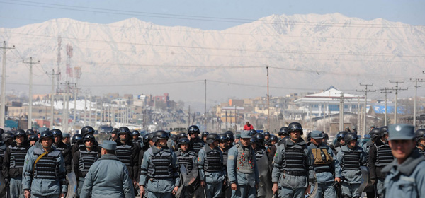 Afghan policemen watch demonstrators as they shouts anti-US slogans during a protest against Koran desecration in Kabul on February 23, 2012. The Taliban exhorted Afghans on February 23 to attack and kill foreign troops to avenge the burning of Korans at a US-run base, but stopped short of cutting off contacts with American officials in Qatar. AFP PHOTO/SHAH Marai (Photo credit should read SHAH MARAI/AFP/Getty Images)