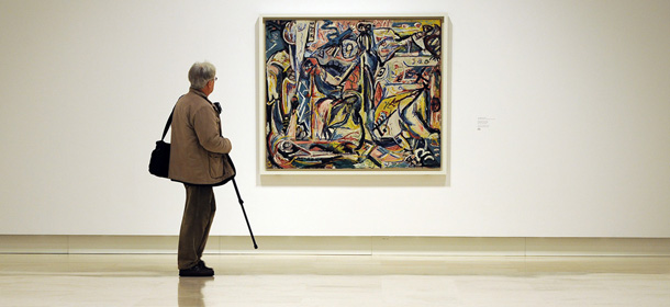A journalist, holding a monopod, looks at "Circumsision" by US artist Jackson Pollock belonging to the Guggenheim foundation, as part as an exhibition called "Guggenheim Collection: The American Avant-Garde 1945-1980" on February 6, 2012 at the Palazzo delle Esposizioni in Rome. The exhibition, running from February 7 to May 6, showcases more than 60 exemplary works produced during the decades after World War II from the Guggenheim museum's permanent collection. AFP PHOTO / GABRIEL BOUYS (Photo credit should read GABRIEL BOUYS/AFP/Getty Images)