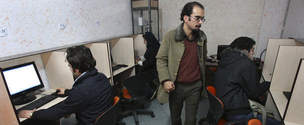 Iranians work in an internet cafe in central Tehran, Iran, Tuesday, Jan. 18, 2011. Iran's top police chief envisions a new beat for his forces: patrolling cyberspace. "There is no time to wait," Gen. Ismail Ahmadi Moghaddam said last week at the opening of a new police headquarters in the Shiite seminary city of Qom. "We will have cyber police all over Iran." The first web watchdog squads are planned in Tehran this month_ another step in Iran's rapidly expanding focus on the digital world as cyber warfare and online sleuthing take greater prominence with the Pentagon's new Cyber Command and the secrets spilled to WikiLeaks. (AP Photo/Vahid Salemi)