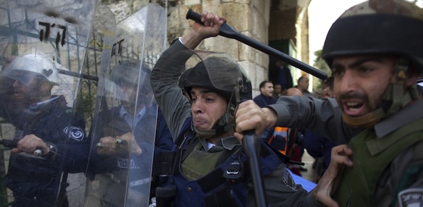 Israeli border policemen raise their batons to disperse Palestinian protesters in the old city of Jerusalem on February 24, 2012 as clashes broke out between Israeli police and "hundreds" of Palestinian stone-throwers at the flashpoint Al-Aqsa mosque compound, police said. AFP PHOTO/MENAHEM KAHANA (Photo credit should read MENAHEM KAHANA/AFP/Getty Images)