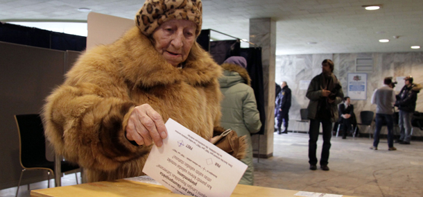 A Latvian woman casts her ballot paper at a polling station during a language referendum in Riga, Latvia, Saturday, Feb. 18, 2012. Latvia on Saturday opened a referendum on whether Russian should become the Baltic country's second national language, a poll that is likely to fail and widen the rift in an already divided society. (AP Photo/Roman Koksarov)