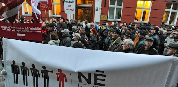 Supporters of the Harmony Center party stage a protest in front of the parliament building during its opening session in Riga October 17, 2011. Several thousand supporters of a pro-Russian party that topped the polls in Latvia's general election rallied at the Baltic state's parliament Monday to demand a landmark slot in government. The demonstrators, numbering around 3,000 according to an AFP reporter, blew vuvuzelas and waved banners blasting "ethnic discrimination" which saw the Harmony Centre shut out of a coalition whose future is in doubt after a revolt by lawmakers. (Banner reads: "No to ethnic discrimination") AFP PHOTO / Raitis Purins (Photo credit should read Raitis Purins/AFP/Getty Images)