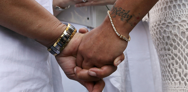 NEW YORK, NY - JULY 26: Ruth Johansen Diaz and Evelyn Johansen Diaz hold hands during their wedding ceremony in Washington Square Park on July 26, 2011 in New York City. Same-sex couples were married for free today in Washington Square Park; July 24 was the first day gay couples were allowed to legally marry in New York state. (Photo by Mario Tama/Getty Images)