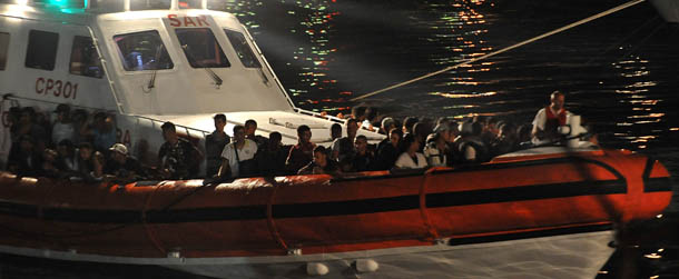 LAMPEDUSA, ITALY - AUGUST 24: An Italian coastguard boat carrying migrants of an undetermined nationality sails into the island port on August 24, 2011 in Lampedusa, Italy. Over 50,000 refugees have risked the crossing to Italy since the start of the year, as reported by The United Nations High Commission for Refugees (UNHCR), with the small island of Lampedusa a focal point for the migrations as political turmoil continues to flare across North Africa. (Photo by Tullio M. Puglia/Getty Images)