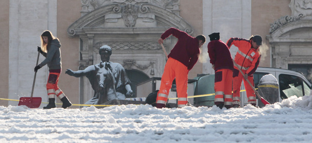 Workers shovel snow from the steps of Rome's Campidoglio Capitol Hill, Saturday, Feb. 11, 2012. After no big snowfall for 26 years, Rome was hit by its second snowstorm in a week. Snow blanketed Rome's suburbs Friday morning, and by evening, it started sticking in the capital's center. Within two hours, at least 5 cm (2 inches) had accumulated. (AP Photo/Gregorio Borgia)