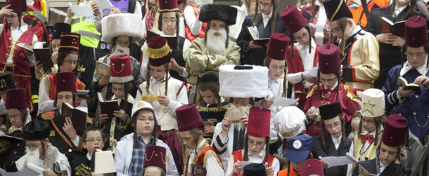 Israeli children in Purim costumes read the Esther scrolls at a synagogue in the Israeli town of Bnei Brak near Tel Aviv on March 7, 2012. The carnival-like Purim holiday is celebrated from the evening of March 7 with parades and costume parties to commemorate the deliverance of the Jewish people from a plot to exterminate them in the ancient Persian empire 2,500 years ago, as recorded in the Biblical Book of Esther. AFP PHOTO/MENAHEM KAHANA (Photo credit should read MENAHEM KAHANA/AFP/Getty Images)