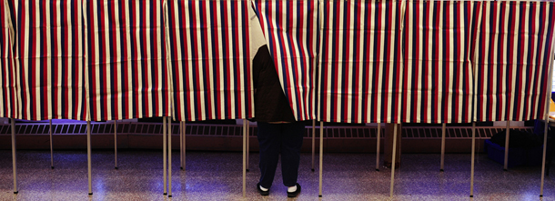 A lone voter casts her vote at a polling station inside a school, during the Super Tuesday Republican primary elections in Cambridge, Massaschusetts, March 6, 2012. Republican voters make their way to the polls in the Super Tuesday primary elections in 10 states and 437 delegates at stake. AFP PHOTO/Emmanuel Dunand (Photo credit should read EMMANUEL DUNAND/AFP/Getty Images)