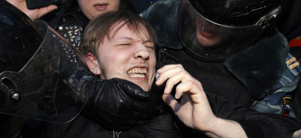 Russian police officers detain an opposition protester during a protest near the Central Election Committee in Moscow, Monday, March 5, 2012. Demonstrators are contesting the outcome of the vote, pointing to a campaign heavily slanted in Putin's favor and to reports of widespread violations in Sunday's ballot. (AP Photo/Ivan Sekretarev)