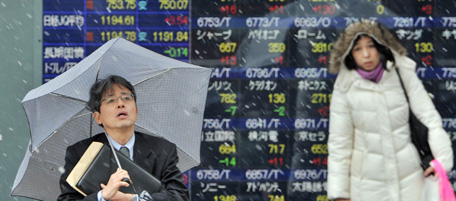 A businessman stands in front of an electronic board showing the Nikkei 225 index at the Tokyo Stock Exchange in Tokyo on January 20, 2012. Tokyo stocks rose 1.33 percent Jan 20 morning as a firming euro helped export issues gain ground, brokers said. The Nikkei 225 index at the Tokyo Stock Exchange gained 115.03 points to 8,754.71 by the break after topping the 8,700 mark for the first time since early November. AFP PHOTO / KAZUHIRO NOGI (Photo credit should read KAZUHIRO NOGI/AFP/Getty Images)