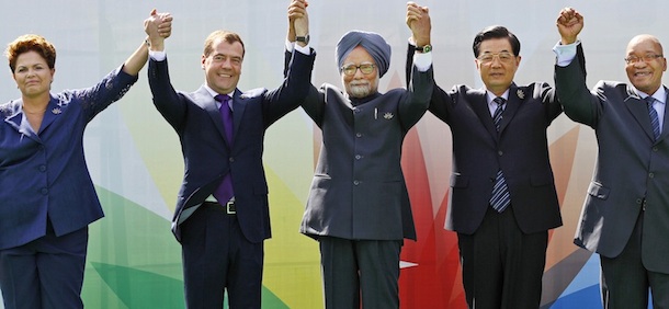 From left to right, Brazil's President Dilma Rousseff, Russian President Dmitry Medvedev, Indian Prime Minister Manmohan Singh,Chinese President Hu Jintao and South African President Jacob Zuma raise their arms together during the group picture for the BRICS 2012 Summit in New Delhi, India, Thursday, March 29, 2012. Heads of States of the five nations are meeting in the Indian capital Thursday. (AP Photo/Saurabh Das)