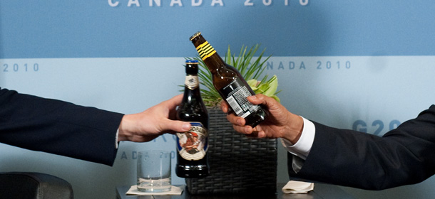US President Barack Obama (R) and British Prime Minister David Cameron (L) clink bottles of beer as they trade bottles to settle a bet on the US-UK World Cup Soccer game during a meeting on the sidelines of the G20 Summit in Toronto, Ontario, Canada, June 26, 2010. Obama gave Cameron a case of 312 Beer and Cameron gave Obama a case of Hobgoblin. AFP PHOTO / Saul LOEB (Photo credit should read SAUL LOEB/AFP/Getty Images)