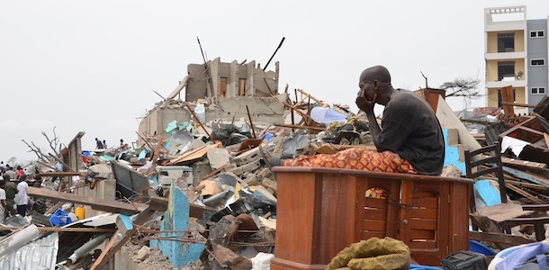 A man sits among the debris left by yesterday's explosion at the Mpila district of Brazzaville on March 5, 2012. Congo issued a plea for international help Monday as soldiers began recovering bodies from an area devastated by huge explosions at a munitions depot that left more than 150 dead and 1,000 injured. President Denis Sassou Nguesso announced a curfew in the capital Brazzaville and set up an exclusion zone around the devastated eastern district of Mpila, following an emergency cabinet meeting in the early hours of the morning. AFP PHOTO / PATRICK FORT (Photo credit should read PATRICK FORT/AFP/Getty Images)