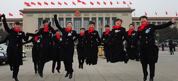 Hostesses jump outside the Great Hall of the People before the opening session at the 11th National Committee of the Chinese People's Political Consultative Conference (CPPCC) in Beijing on March 3, 2012. China's parliament, also called the National People's Congress (NPC), will open its last annual session under the current leadership on March 5, amid what analysts say may be a bitter power struggle to replace outgoing Communist Party rulers. AFP PHOTO / Mark RALSTON (Photo credit should read MARK RALSTON/AFP/Getty Images)