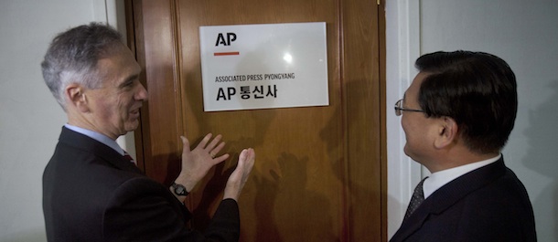 Associated Press President Tom Curley gestures to the Associated Press Pyongyang bureau sign which he had just hung on to the office door to open a new AP office in Pyongyang, North Korea on Monday Jan. 16, 2012. On the right is Korean Central News Agency President Kim Pyong Ho. The AP opened its newest bureau in North Korea, making it the first international news organization with a full time presence to cover news from North Korea in words, pictures, and video. (AP Photo/David Guttenfelder)