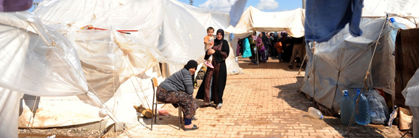 Syrian refugees go about their daily lives at the Reyhanli refugee Camp in Antakya, on March 15, 2012. Around 1,000 Syrian refugees, including a defecting general, crossed into Turkey in the last 24 hours, the foreign ministry said on Thursday, the one-year anniversary of the Syrian revolt. Ankara accused the Syrian leadership of planting landmines near its border with Turkey along routes used by refugees fleeing the Damascus regime's deadly crackdown on dissent. AFP PHOTO / BULENT KILIC (Photo credit should read BULENT KILIC/AFP/Getty Images)