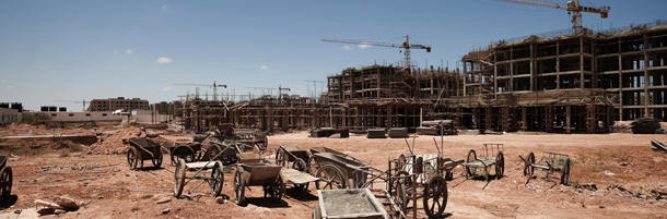 TO GO WITH AFP STORY BY JEAN-PIERRE CAMPAGNE
A picture shows the abandoned construction site of the "New Benghazi" project in the Libyan rebel stronghold of Benghazi on June 14, 2011. Hundreds of cement mixers, cranes, and forklifts stand silent on a massive construction site among grey buildings left unfinished when Chinese workers abandoned Libya as fighting flared. AFP PHOTO/GIANLUIGI GUERCIA (Photo credit should read GIANLUIGI GUERCIA/AFP/Getty Images)