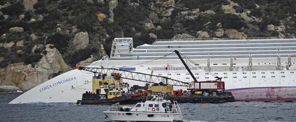 Technicians work near the cruise liner Costa Concordia lying aground in front of the Isola del Giglio (Giglio island) on January 27, 2012 after hitting underwater rocks on January 13. Official sources said the same day that here are still 18 people officially missing after the Costa Concordia cruise liner crashed off the coast of Tuscany two weeks ago, including a five-year-old girl. AFP PHOTO / FILIPPO MONTEFORTE (Photo credit should read FILIPPO MONTEFORTE/AFP/Getty Images)