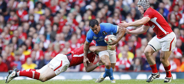 Wales' Jamie Roberts, left, and teammate Jonathan Davies, right, tackle Italy's Gonzalo Canale during their Six Nations rugby union match at the Millennium stadium in Cardiff, Wales, Saturday, March 10, 2012. (AP Photo/Alastair Grant)