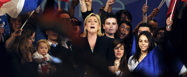 Marine Le Pen, French far-right Front National (FN) party's candidate for the 2012 presidential election, sings the French national anthem surrounded by supporters during a campaign meeting, on March 4, 2012 in Marseille, southern France. Marine Le Pen called on March 2, 2012 for French mayors to "assume their responsibility" and endorse her far-right candidacy ahead of a looming deadline that could see her wiped from the presidential ballot. AFP PHOTO / GERARD JULIEN (Photo credit should read GERARD JULIEN/AFP/Getty Images)