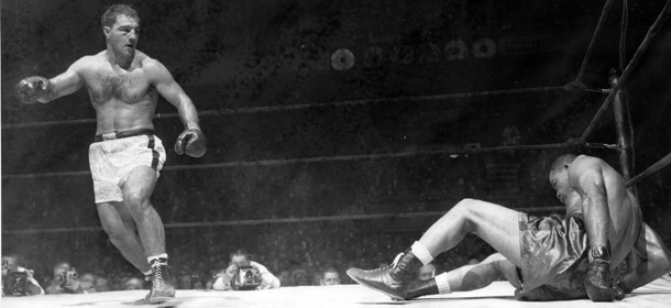 Joe Louis falls to the canvas in first knockdown of 8th and final round of his scheduled 10-rounder with Rocky Marciano, left, in Madison Square Garden in New York City, Oct. 26, 1951. Louis went down for count of eight only to get up again to a flurry of blows from Marciano, sending him down again. The referee signaled the end of the fight in 2:36 of the round. (AP Photo)