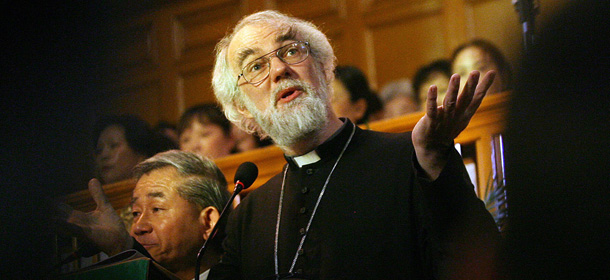 Shanghai, CHINA: The Archbishop of Canterbury Rowan Williams (C) reads a sermon with the help of a Chinese translator during a Thanksgiving service at the Mu-En Church in Shanghai, 08 October 2006. Williams, who is the leader of the world's Anglican communion, arrived 08 October in China for the first time in more than a decade on a two-week visit that will include talks with religious and government officials and he will visit five cities, starting in Shanghai before moving on to Nanjing, Wuhan and Xian before ending in Beijing. AFP PHOTO/Mark RALSTON (Photo credit should read MARK RALSTON/AFP/Getty Images)