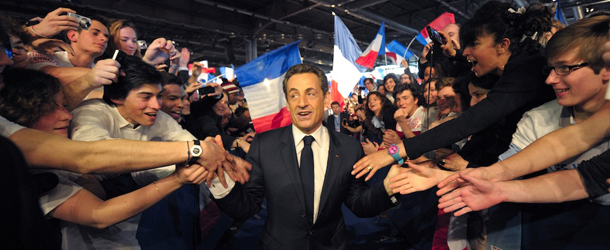 France's President and candidate for the upcoming re-election, Nicolas Sarkozy is cheered by supporters as he arrives for a meeting in Villepinte, north of Paris, France, as part of his electoral campaign, Sunday, March 11, 2012. (AP Photo/Philippe Wojazer, Pool)