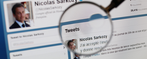 A picture taken on February 15, 2012 shows a magnifying glass in front of a screen featuring a page of the official Twitter account of France's president Nicolas Sarkozy. Nicolas Sarkozy is today to reveal the worst kept secret in French politics by officially launching his re-election campaign, changing up a gear with fewer than ten weeks to polling day. AFP PHOTO THOMAS COEX (Photo credit should read THOMAS COEX/AFP/Getty Images)