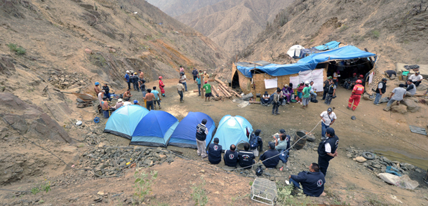 General view of a makeshift camp outside the entrance of Cabeza de Negro copper mine, 1,300 meters over the sea level in the Andes, east of Ica, 325 km south of Lima, on April 8, 2012. The miners, who have been trapped 250 meters underground in a horizontal tunnel for four days, reported to rescuers through a hose, that they are unharmed but that some are now showing symptoms of dehydration and mental distress. AFP PHOTO/CRIS BOURONCLE (Photo credit should read CRIS BOURONCLE/AFP/Getty Images)