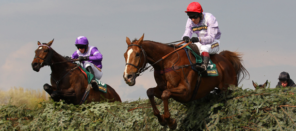 LIVERPOOL, ENGLAND - APRIL 13: Chance Du Roy (4) ridden by Richard Johnson clears the last fence ahead of the eventual winner, Always Waining (10), ridden by Tom O'Brien in The John Smith's Topham Steeple Chase held at Aintree Racecourse on April 13, 2012 in Liverpool, England. (Photo by Alex Livesey/Getty Images)