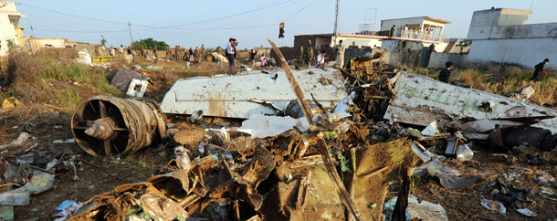 Pakistani soldiers stand next to the wreckage in Hussain Abad after a Bhoja Air Boeing 737 plane crashed on the outskirts of Islamabad on April 21, 2012. Pakistan has launched an investigation after a passenger jet crashed while attempting to land during a thunderstorm, with all 127 people on board believed dead. The Bhoja Air flight from Karachi burst into flames after coming down in fields as it approached the city's international airport. AFP PHOTO / AAMIR QURESHI (Photo credit should read AAMIR QURESHI/AFP/Getty Images)