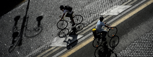 Cyclists take part in a protest rally calling for more and safer bicycle infrastructure, in Rome's central Via dei Fori Imperiali near the Colosseum on April 28, 2012. Thousands of cyclists staged a protest near the Colosseum in Rome on Saturday to draw attention to poor road safety and the lack of provisions for bike lovers in the car-cluttered Eternal City. AFP PHOTO/ FILIPPO MONTEFORTE (Photo credit should read FILIPPO MONTEFORTE/AFP/GettyImages)