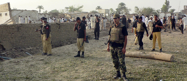 Pakistani police secure the site after a suicide blast on a police station in the Mandan area on the outskirts of Bannu town on September 26, 2009. A suicide bomber blew up a truck packed with explosives outside THE police station in northwest Pakistan, killing five people and wounding 30 others, police said. AFP PHOTO/KARIK ULLAH (Photo credit should read KARIM ULLAH/AFP/Getty Images)