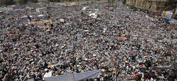 Egyptian protesters attend Friday prayers during a rally at Tahrir Square, Cairo, Egypt Friday, April 20, 2012. Tens of thousands of protesters packed Cairo's downtown Tahrir Square on Friday in the biggest demonstration in months against the ruling military, aimed at stepping up pressure on the generals to hand over power to civilians and bar ex-regime members from running in upcoming presidential elections.(AP Photo/Nasser Nasser)