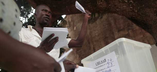 Election workers count ballots after the close of polls, at an outdoor polling station in Bissau, Guinea-Bissau, Sunday, March 18, 2012. Voters in Guinea-Bissau on Sunday chose between nine presidential candidates in the small, coup-prone nation, and citizens said they hoped the winner would finally bring stability and much-needed development after years of turmoil. (AP Photo/Gabriela Barnuevo)