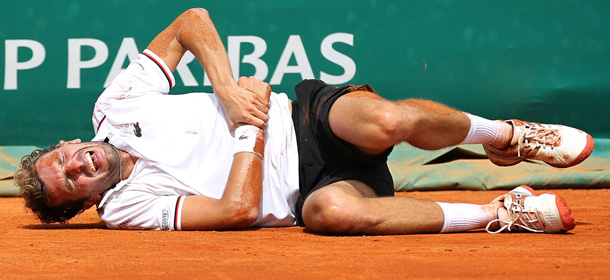 France's Julien Benneteau reacts as he lays on the ground after a fall during his match againt's British Andy Murray during the Monte-Carlo ATP Masters Series Tournament tennis match, on April 19, 2012 in Monaco. Murray won the match after Benneteau injured both his right ankle and arm. AFP PHOTO / VALERY HACHE (Photo credit should read VALERY HACHE/AFP/Getty Images)