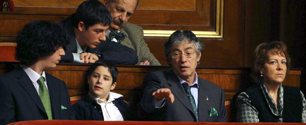 Italian Northern League party leader Umberto Bossi, second from right, accompanied by his sons Renzo, left, Eridano Sirio, second from left, and his wife Manuela Marrone waves after he arrived at the Italian Senate for the first time since he suffered a stroke in March 2004, to attend the final vote on a constitutional reform, in Rome, Wednesday, Nov. 16, 2005. The disputed reform pushed by Premier Silvio Berlusconi's government is the first major change to Italy's constitution since it came into force in 1948. (AP Photo/Alessandra Tarantino)