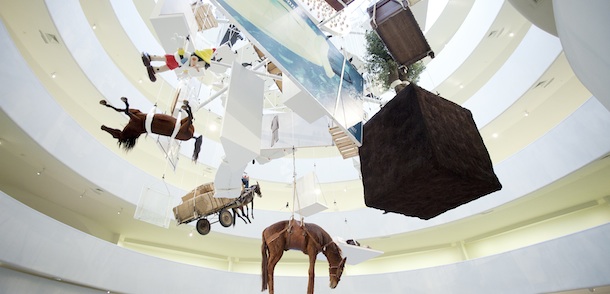 Sculpture by artist Maurizio Cattelan hangs in the rotunda of the Guggenheim Museum, Thursday, Jan. 19, 2012 in New York. The Italian artist's work is on exhibit through Jan. 22. (AP Photo/Mark Lennihan)