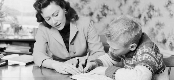 1955: Mrs Boice, a flight instructer by trade, helps her son with his homework. (Photo by Three Lions/Getty Images)