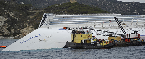 Technicians work near the cruise liner Costa Concordia liying aground in front of the Isola del Giglio (Giglio island) on January 27, 2012 after hitting underwater rocks on January 13. Official sources said the same day that here are still 18 people officially missing after the Costa Concordia cruise liner crashed off the coast of Tuscany two weeks ago, including a five-year-old girl. AFP PHOTO / FILIPPO MONTEFORTE (Photo credit should read FILIPPO MONTEFORTE/AFP/Getty Images)