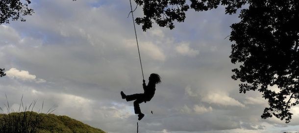 An young boy swings on a robe at the bank of the lake Skarresoe near the village Jyderup, Sjaelland, Denmark, on August 24, 2010. AFP PHOTO / CHRISTOF STACHE (Photo credit should read CHRISTOF STACHE/AFP/Getty Images)