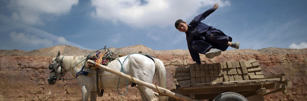 An Afghan labourer dismounts from a horse cart carrying bricks at a kiln in the outskirts of Kabul on April 26, 2012. Poverty and an ongoing insurgency by the ousted Taliban still pose a threat to the stability of the country. AFP PHOTO/ JOHANNES EISELE (Photo credit should read JOHANNES EISELE/AFP/GettyImages)