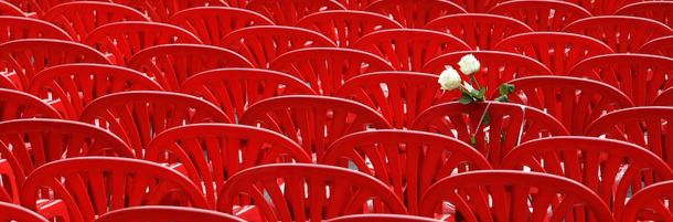 Red chairs are displayed along a main street in Sarajevo as the city marks the 20th anniversary of the start of the Bosnian war on Friday, April,6, 2012. City officials have lined up 11,541 red chairs arranged in 825 rows along the main street that now looks like a red river representing the 11,541 Sarajevans who were killed during the siege.(AP Photo/Amel Emric)