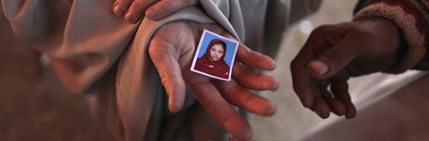 In this Thursday, Feb. 23, 2012 photo, Pakistani Jaffan Muslim, 40, holds a picture of her daughter Arum, 13, who went missing last August while she and others camp near the parliament in Islamabad, Pakistan. The Supreme Court has now given the families a measure of hope by bringing a landmark case against the Inter-Services Intelligence agency, the country's most feared spy network and suspected to be behind most of the abductions. The agency, which works closely with the CIA, operates largely outside of the law. (AP Photo/Muhammed Muheisen)