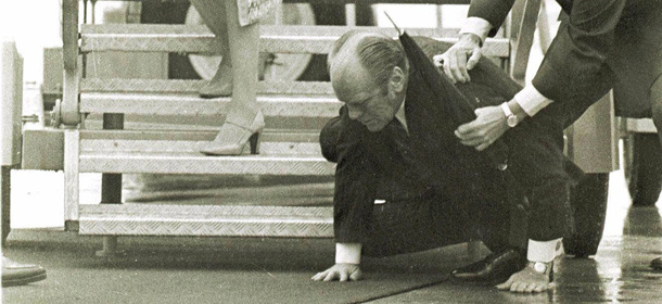 *** FILE *** President Gerald Ford lands on his hands, June 1,1975, after slipping and falling on a wet ramp, while deplaning Air Force One in Salzburg, Austria. A military aide, grabs the president to help break the fall. The president's wife, Betty, is at left. Gerald R. Ford, who picked up the pieces of Richard Nixon's scandal-shattered White House as the 38th and only unelected president in America's history, has died, his wife, Betty, said Tuesday Dec. 26, 2006. He was 93. (AP Photo/pb)