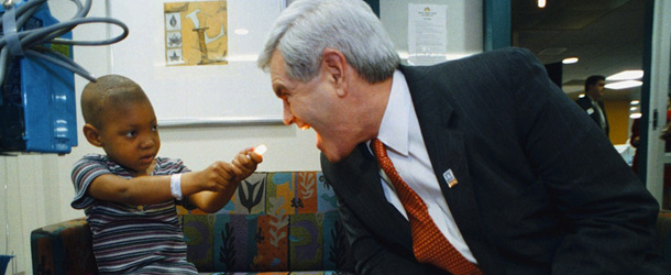 House Speaker Newt Gingrich, right, allows cancer patient Kenwanna Lane, 4, to shine her flashlight into his mouth during a tour of Egleston Children's Hospital Monday, March 16, 1998, in Atlanta, Ga. Gingrich called Kathleen Willey a "credible witness" in relation to alleged unwanted sexual advances by President Clinton in 1993. (AP Photo/Erik S. Lesser)