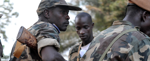 Militarymen sit in a pickup after a meeting with opposition parties on April 15, 2012 in Bissau. The army and opposition parties in Guinea-Bissau are to dissolve all existing institutions and set up a National Transitional Council, a spokesman for the parties said. AFP PHOTO/ SEYLLOU (Photo credit should read SEYLLOU/AFP/Getty Images)