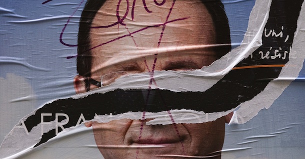 A picture taken on April 24, 2012 in Paris, shows a torn campaign poster of Socialist Party (PS) candidate for the 2012 French presidential election Francois Hollande. Socialist frontrunner Francois Hollande and incumbent Nicolas Sarkozy launched the campaign for France's presidential run-off on April 23, 2012 with the far-right set to play a key role after a record result. AFP PHOTO/JOEL SAGET (Photo credit should read JOEL SAGET/AFP/Getty Images)