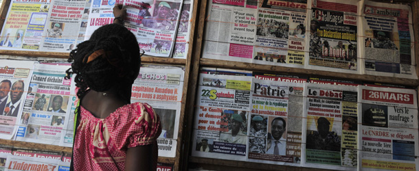A woman reads a local newspaper on April 4, 2012 in Bamako on the situation in the north. World leaders scrambled to stop Mali's descent into chaos, two weeks after a coup in Bamako touched off a sequence which saw Tuareg rebels backed by radical Islamists conquer half the country. AFP PHOTO / ISSOUF SANOGO (Photo credit should read ISSOUF SANOGO/AFP/Getty Images)