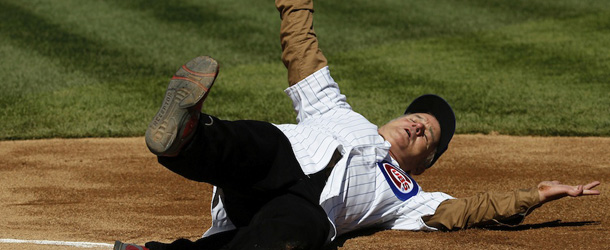 Actor Bill Murray slides into home after rounding the bases before throwing out a ceremonial first pitch before a opening day baseball game between the Chicago Cubs and the Washington Nationals Thursday, April 5, 2012, in Chicago. The Nationals won 2-1. (AP Photo/Charles Rex Arbogast)