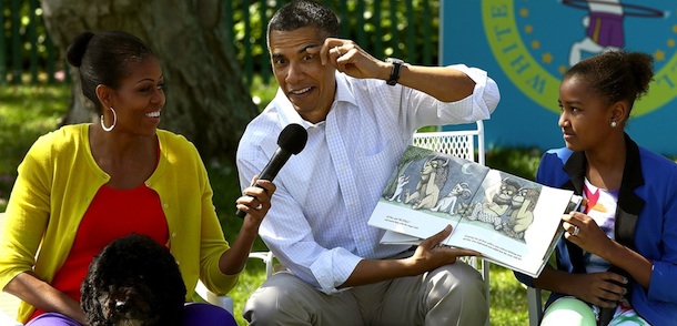 WASHINGTON, DC - APRIL 09: U.S. President Barack Obama acts out a part of the story while reading from the book ÃWhere The Wild Things AreÃ with first lady Michelle Obama (L) and his daughter Sasha (R) during the White House Easter Egg Roll on the South Lawn of the White House April 9, 2012 in Washington, DC. Thousands of people people are expected to attend the 134-year-old tradition of rolling colored eggs down the White House lawn that was started by President Rutherford B. Hayes in 1878. (Photo by Win McNamee/Getty Images)